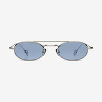 Sunglasses with oval lenses and thin metal frame on a white background