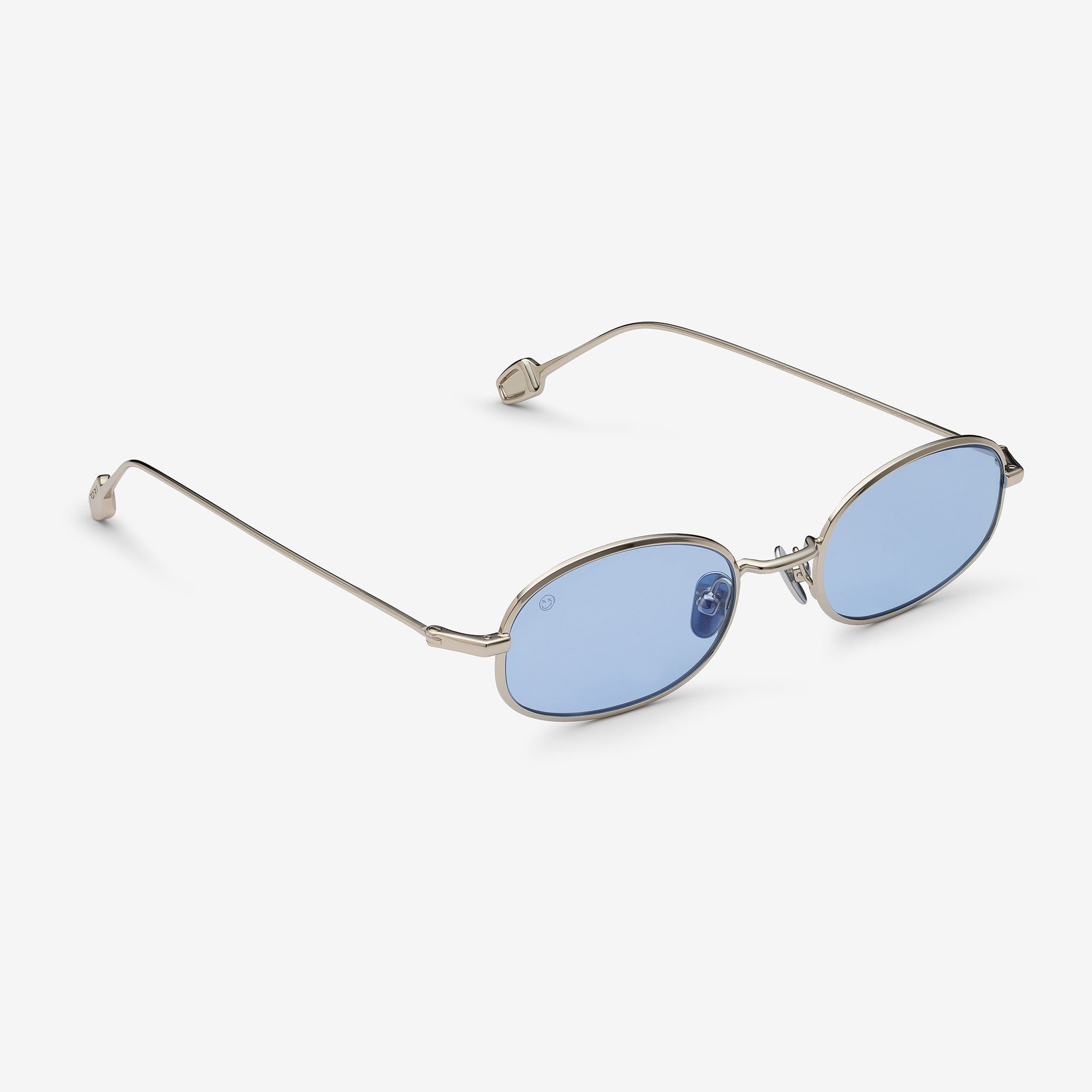 Sunglasses with blue lenses and thin metal frame on a white background