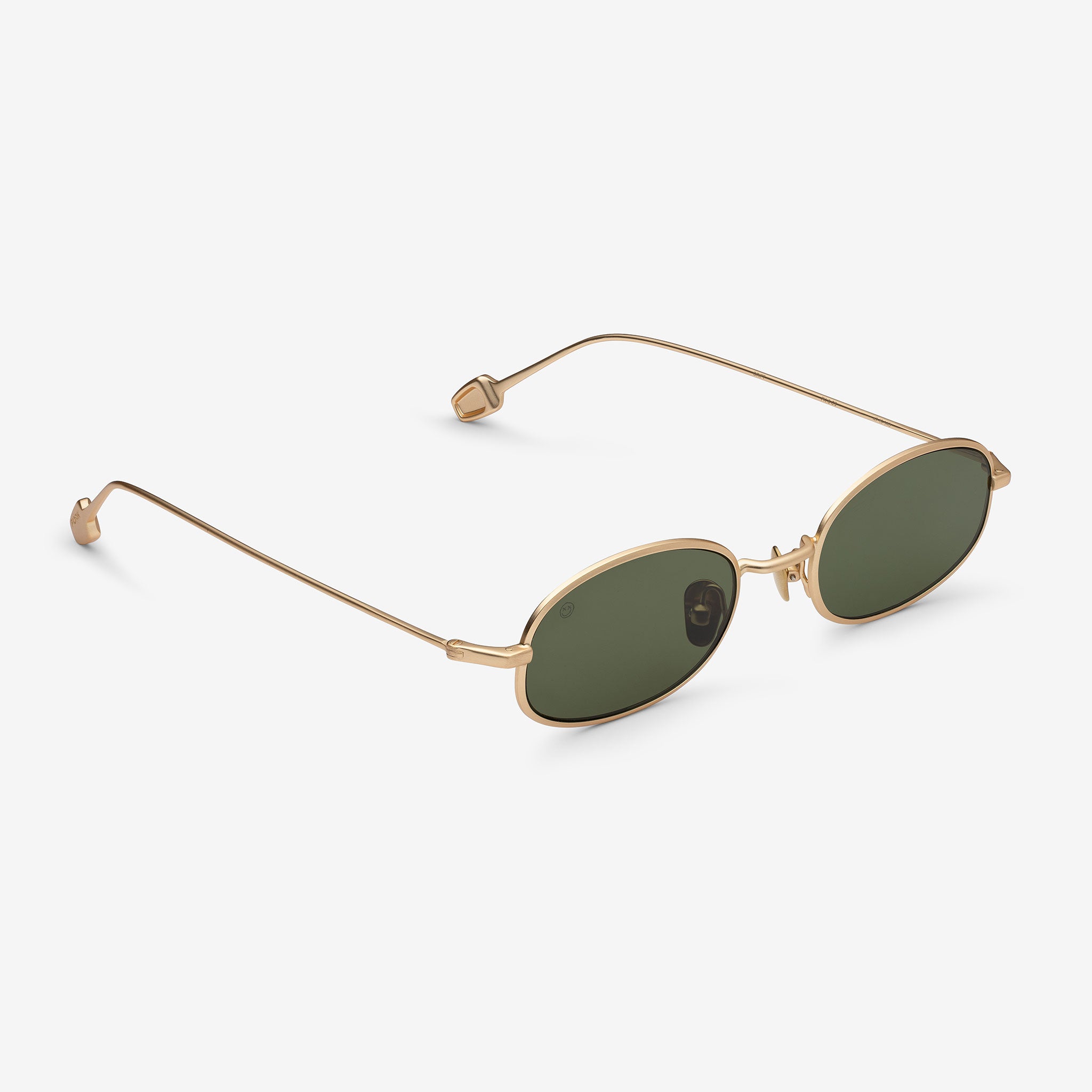 Gold-framed sunglasses with green lenses on a white background