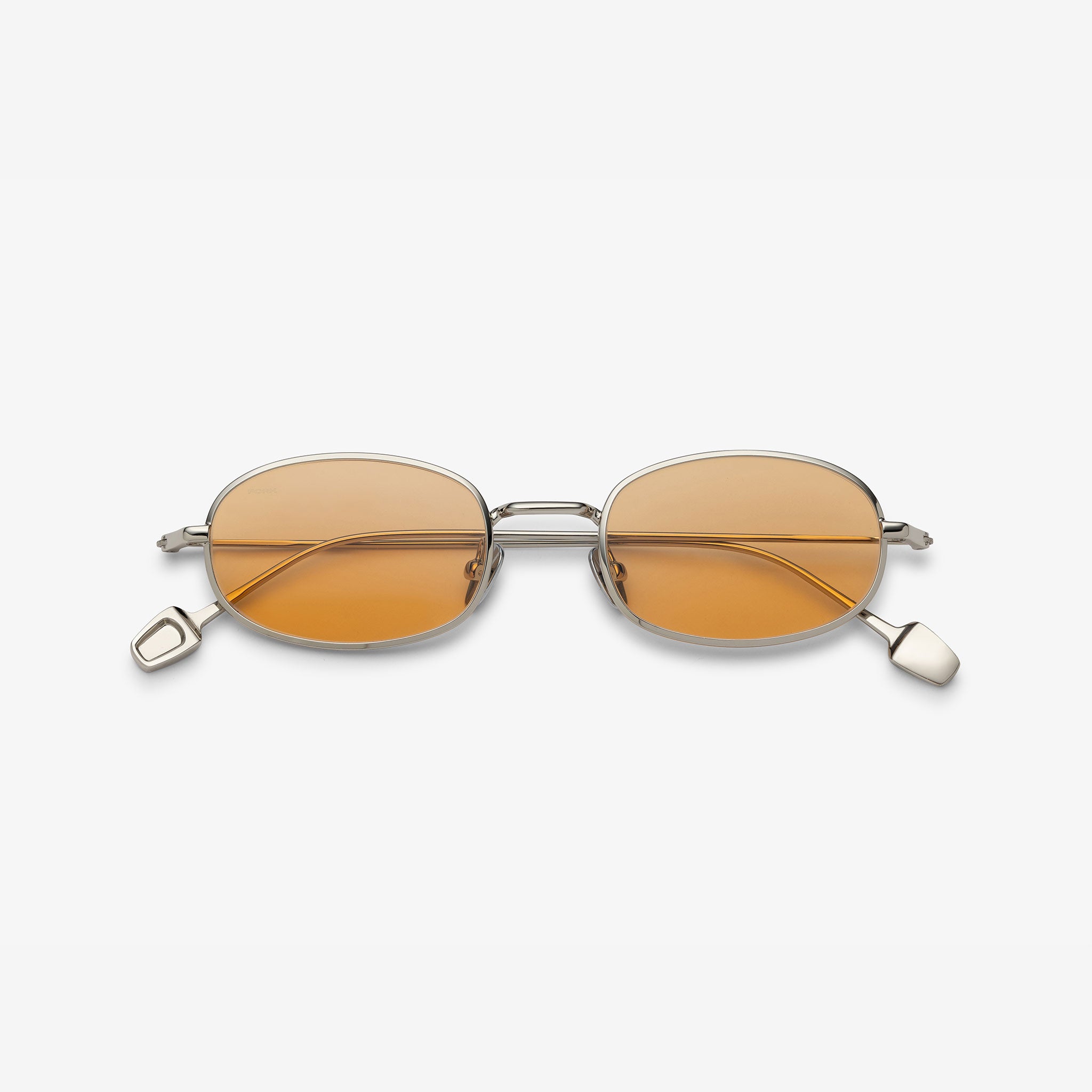 Small round sunglasses with gold frames and orange lenses on a white background