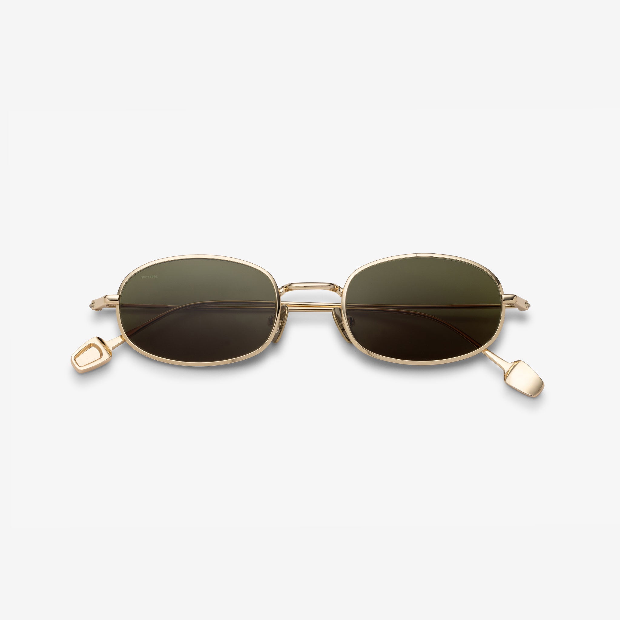 Gold-framed sunglasses with dark lenses on a white background